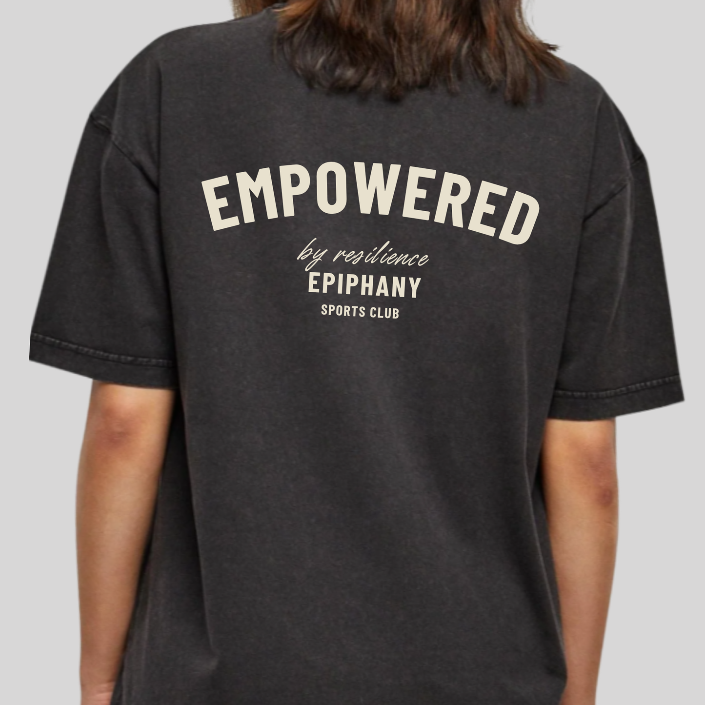 Women's back oversized acid wash T-shirt featuring 'Empowered by Resilience' design.