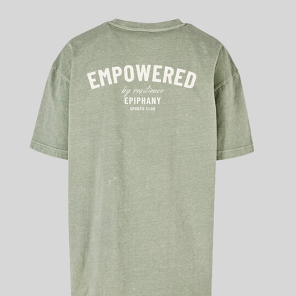 Back view of women's oversized acid wash t-shirt in green with 'Empowered by Resilience' text.